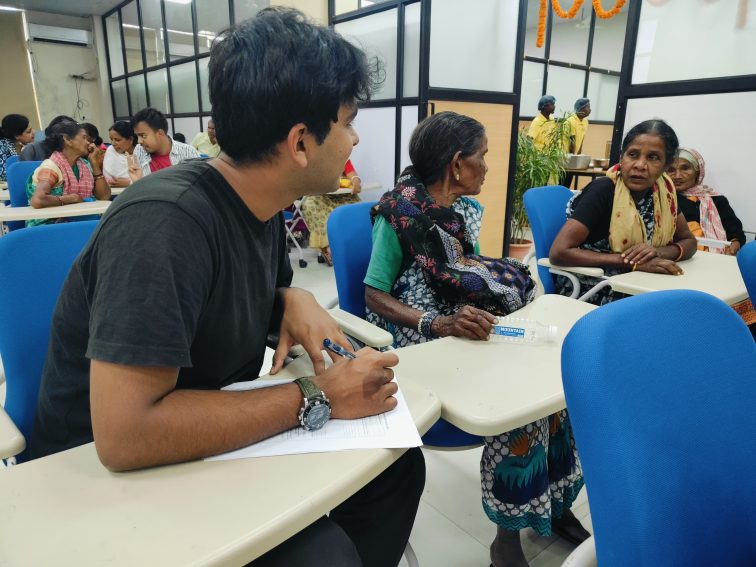 A person speaking with two people at a table